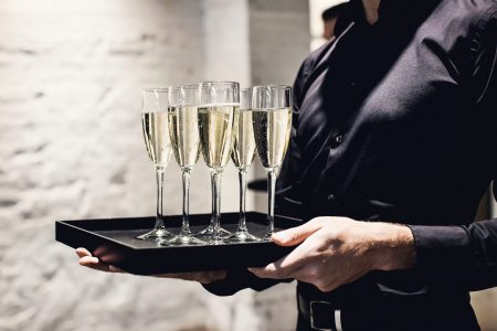 A,Waiter,Holding,Glasses,With,Champagne,Served,On,A,Tablet